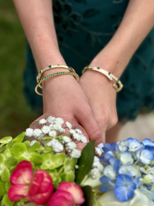 Sienna Bangle in gold and emerald, stacked on the wrist