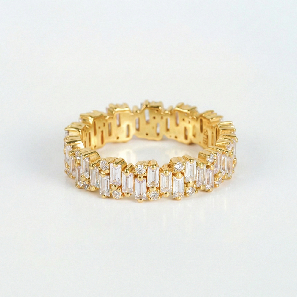 Gold ring with diamond accents on a light gray background