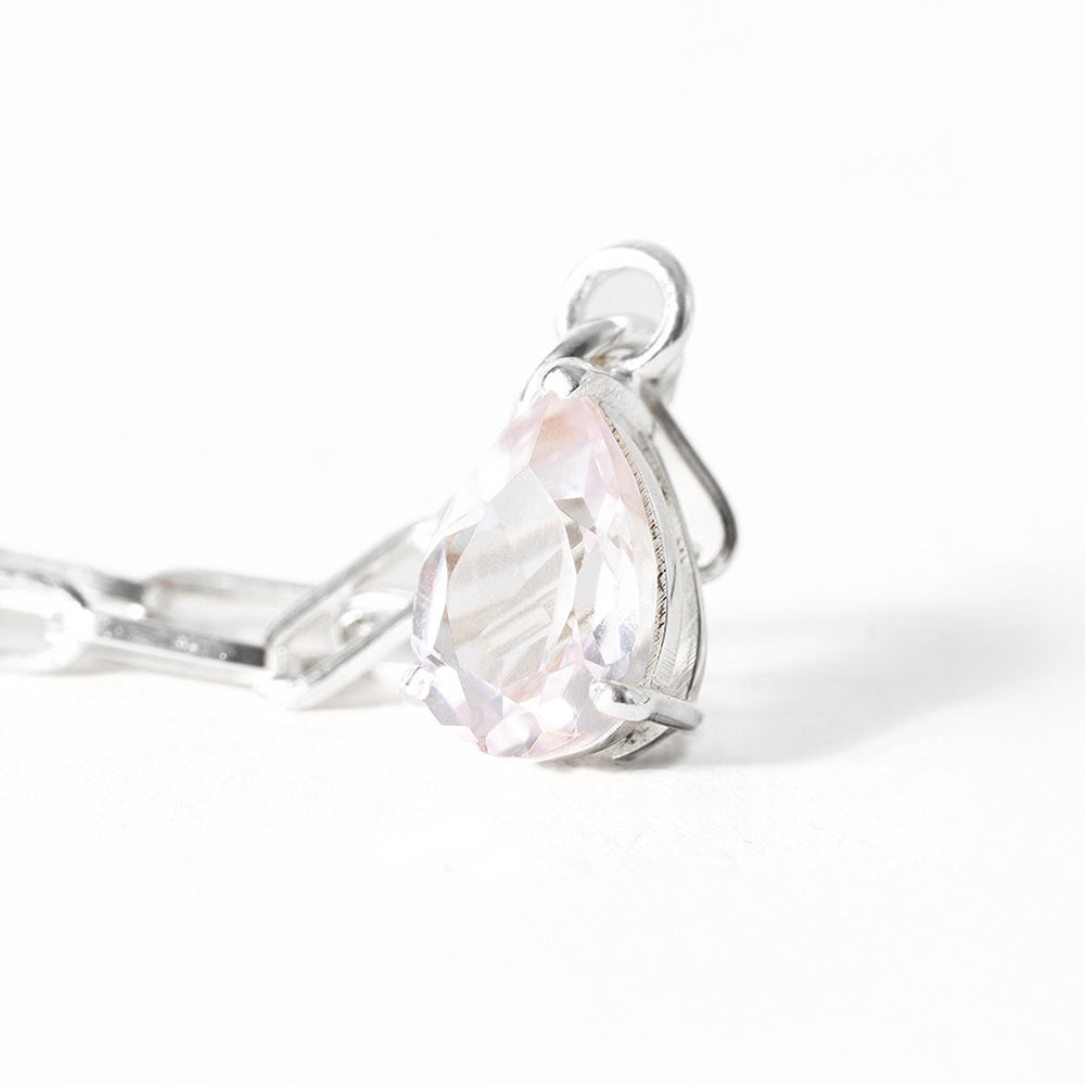 Silver ring with a large heart-shaped gemstone on a white background