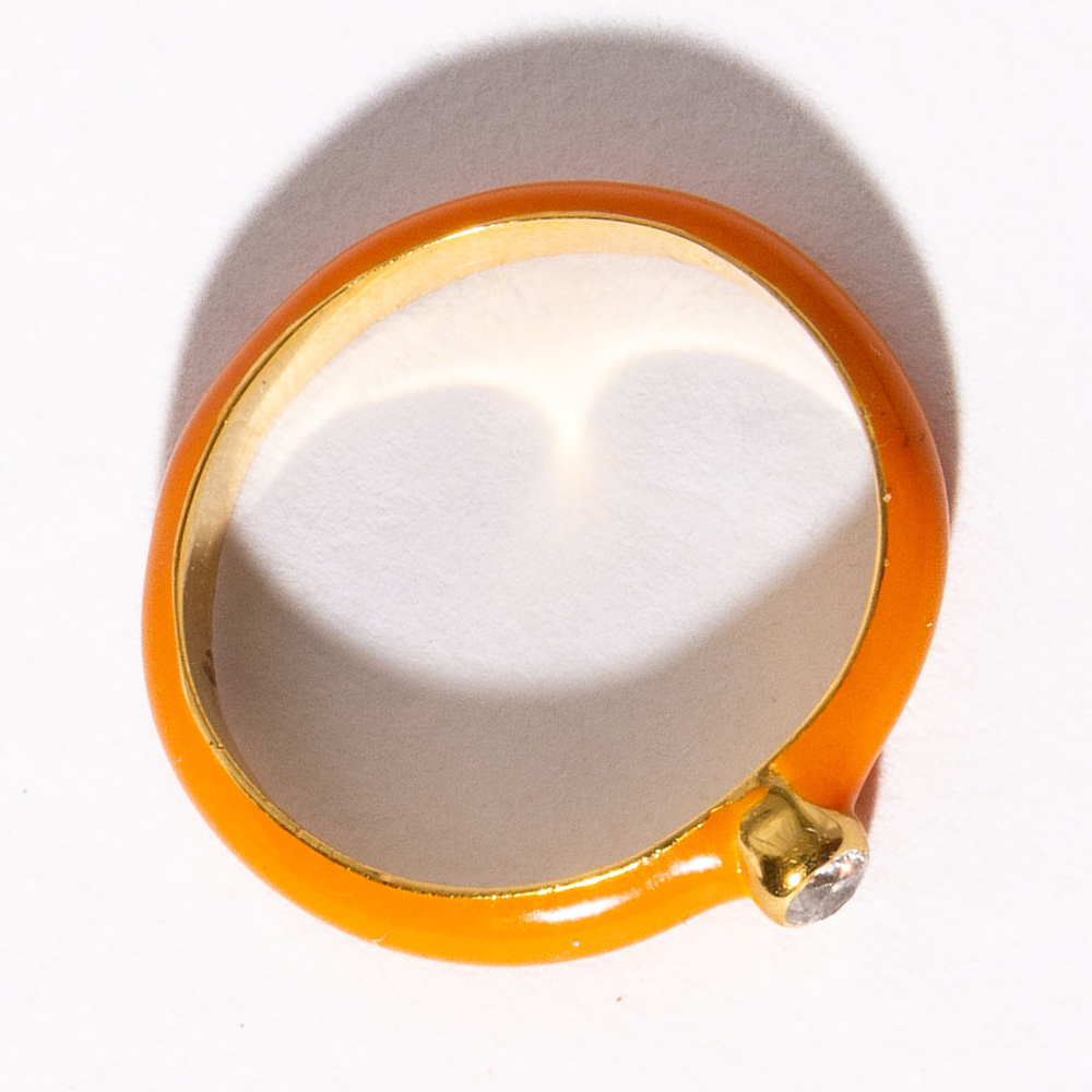 Gold ring with a diamond on a white background