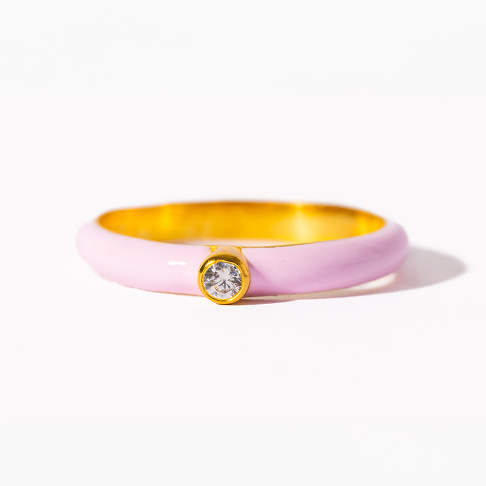 Pink and gold bracelet with a central gemstone on a white background