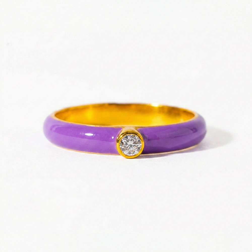 Ring with purple band and gold accents on a white background