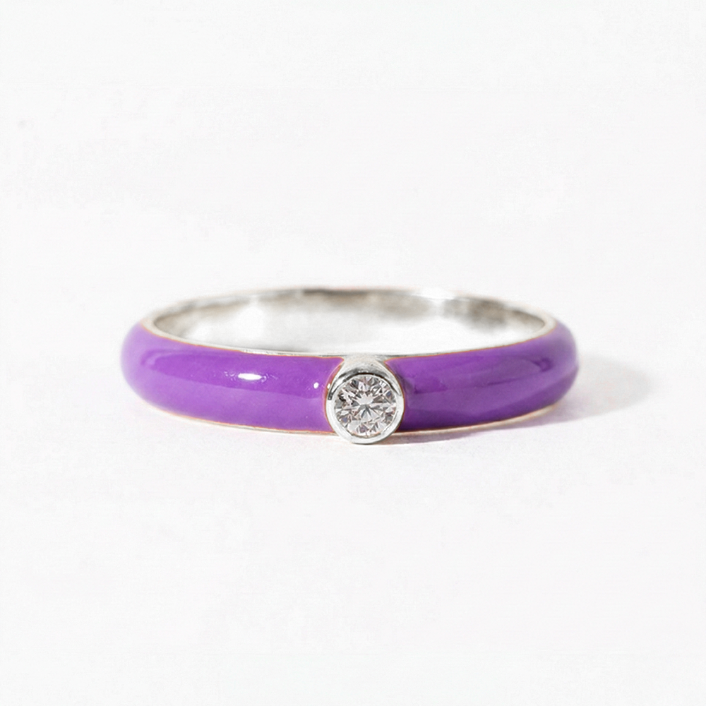 Ring with purple band and diamond on a white background