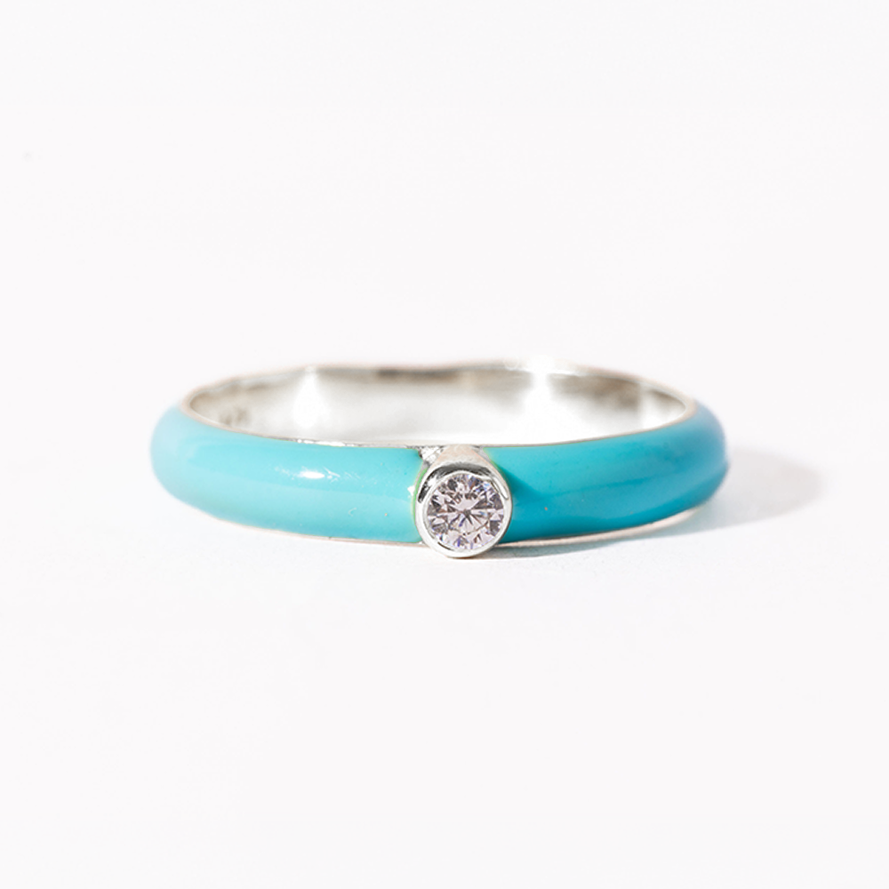 Turquoise ring with a diamond on a white background
