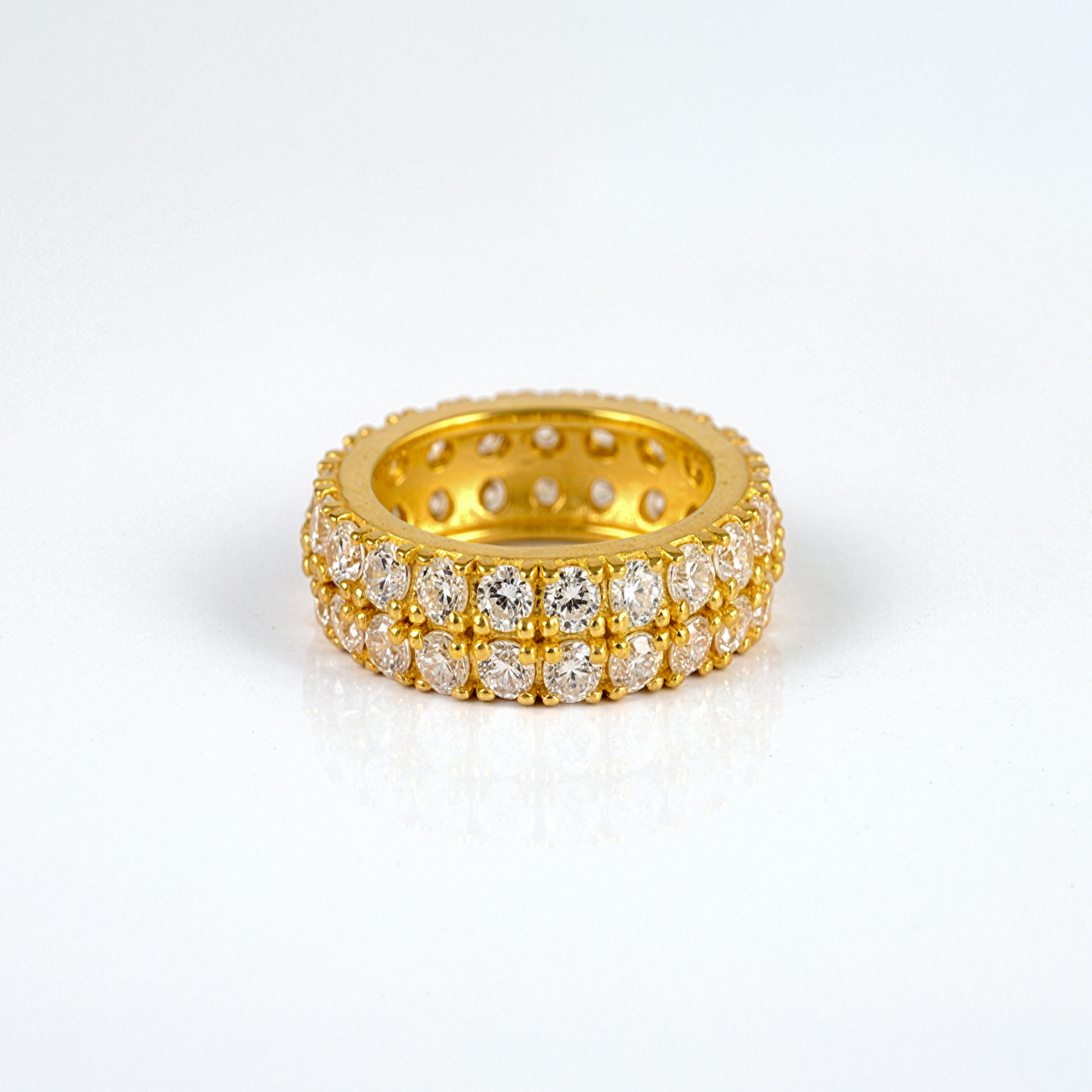Gold ring with diamonds on a white background