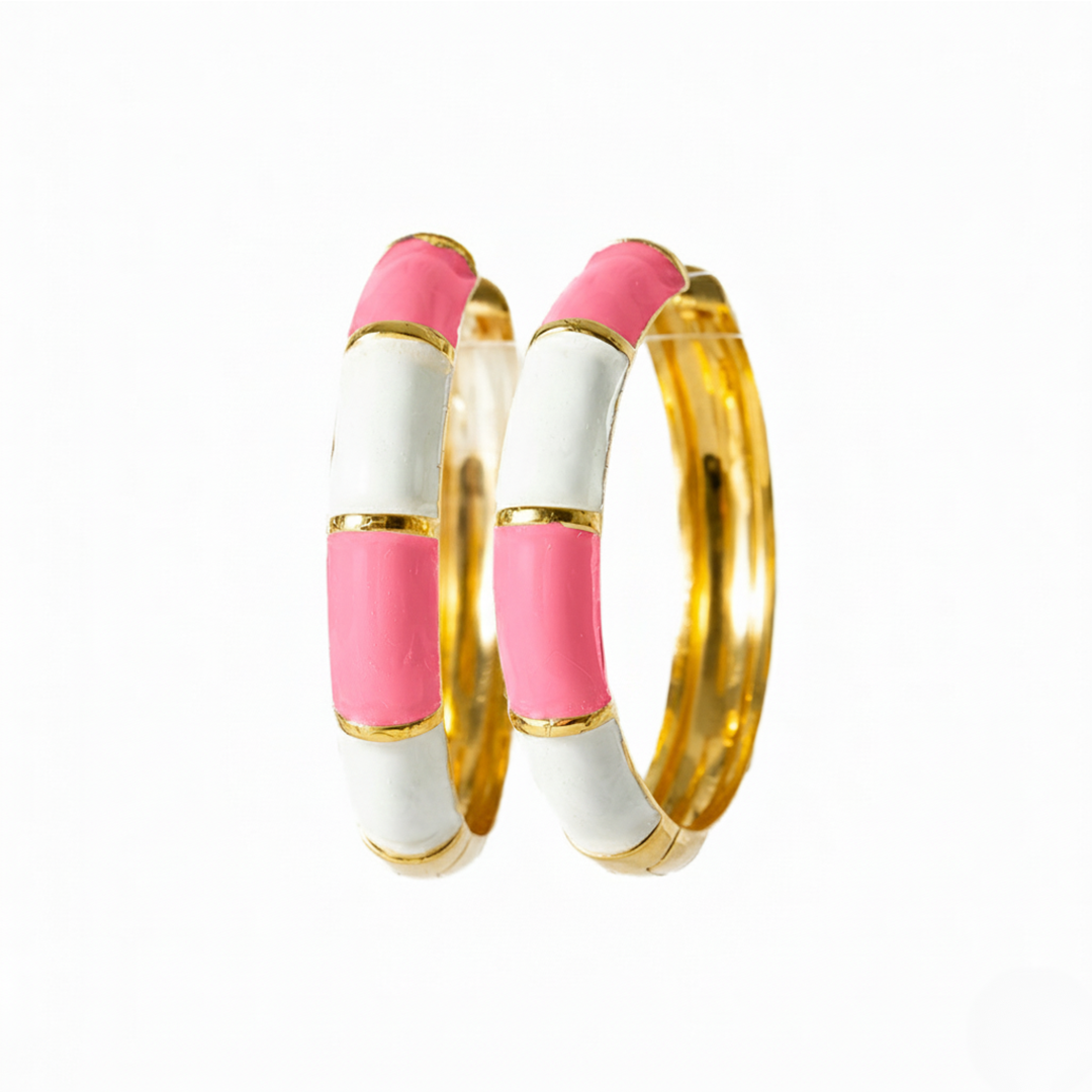 Two bangles with pink and gold accents on a white background