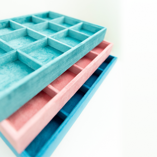 Blue and pink silicone ice cube trays on a white background