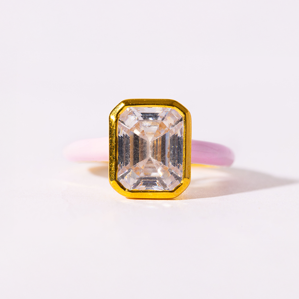Gold ring with a large rectangular diamond on a white background