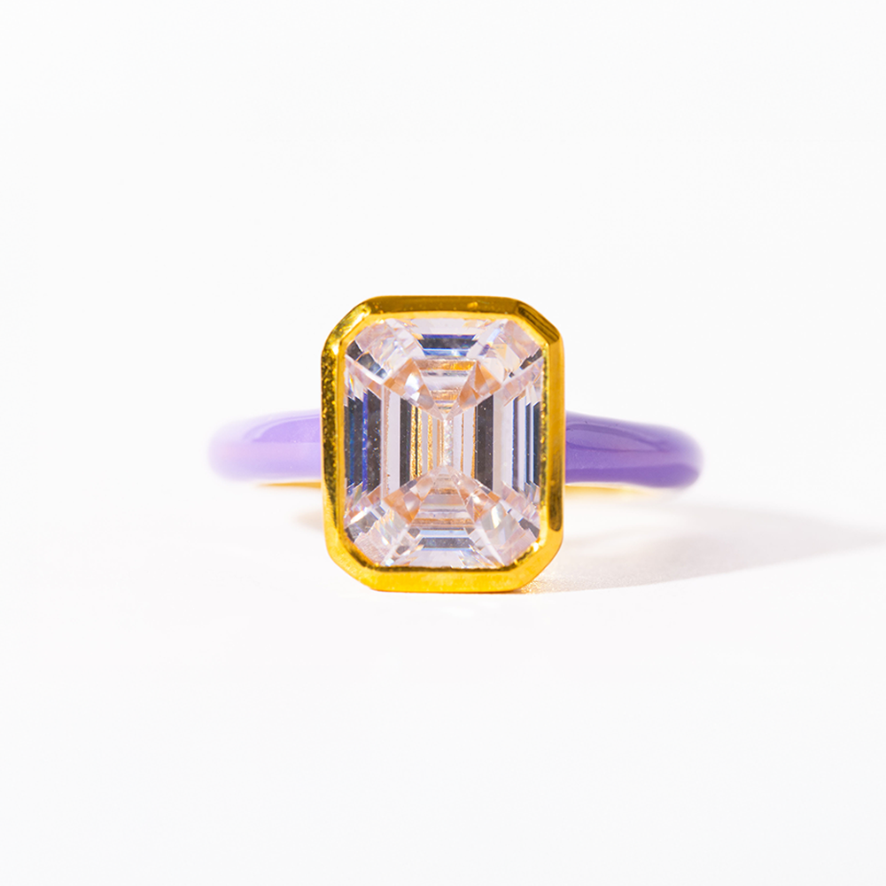 Gold ring with a large rectangular diamond on a white background