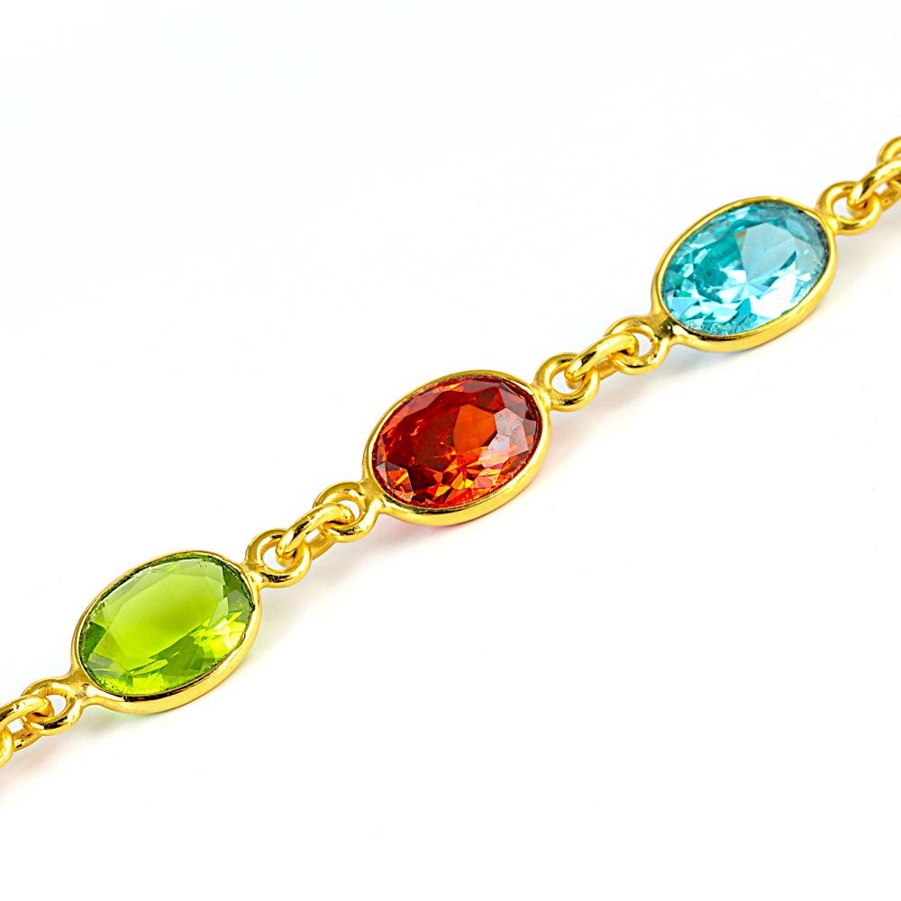 Gold bracelet with multicolored gemstones on a white background
