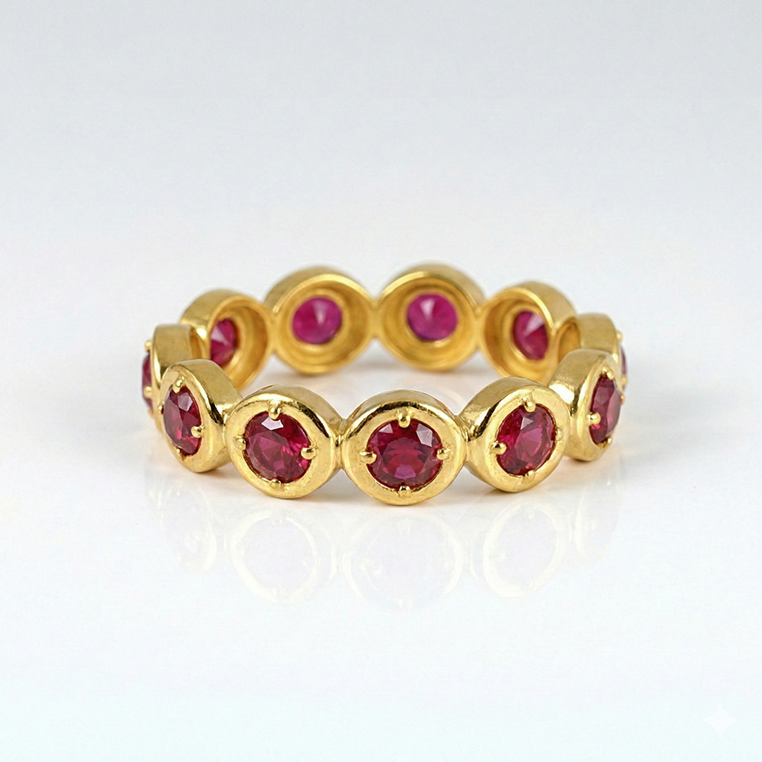 Gold ring with red gemstones on a white background