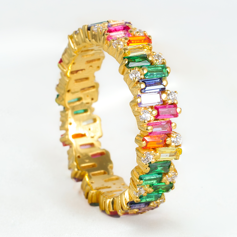 Gold ring with colorful gemstones on a white background
