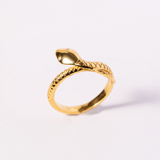 Gold snake-shaped ring on a white background