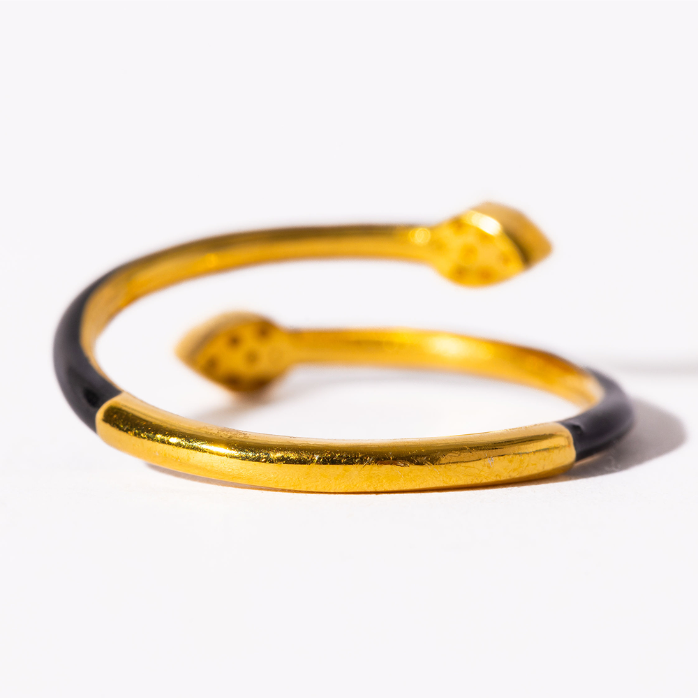 Gold and black bangle on a white background