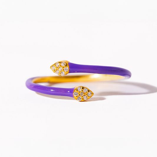 Purple and gold ring with diamond accents on a white background