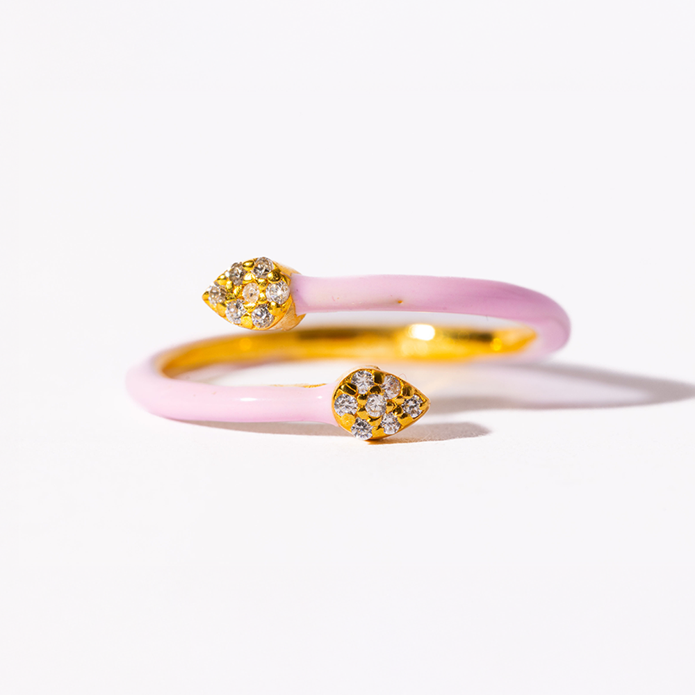 Pair of pink and gold earrings with diamond-like stones on a white background