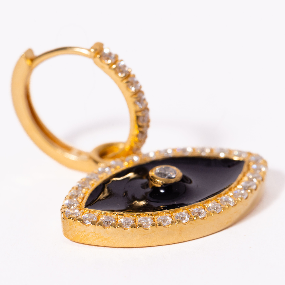 Gold hoop earring with black gemstone and clear stones on a white background