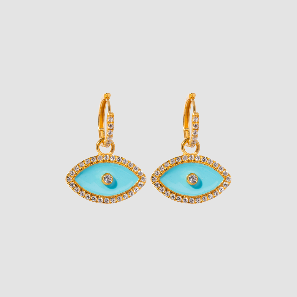Gold and turquoise eye-shaped earrings on a light gray background