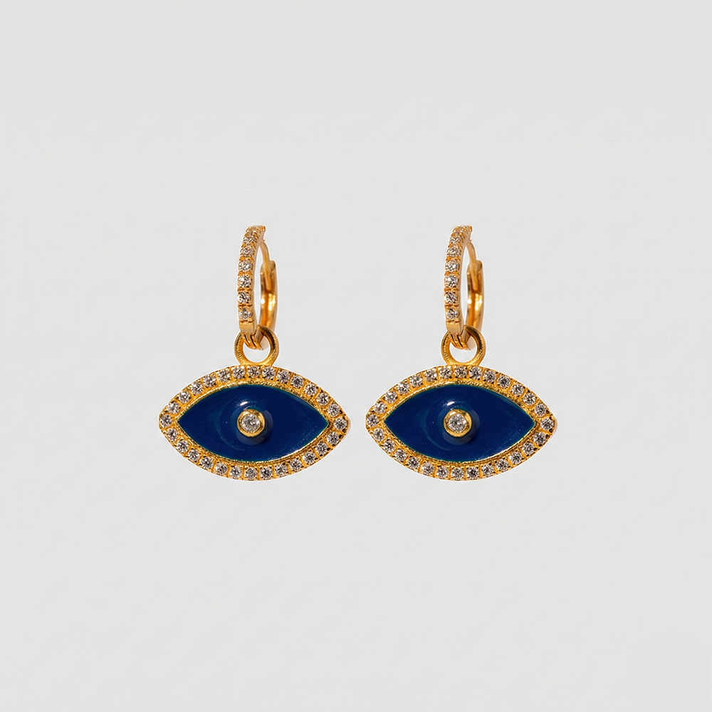 Gold and blue eye-shaped earrings on a light gray background