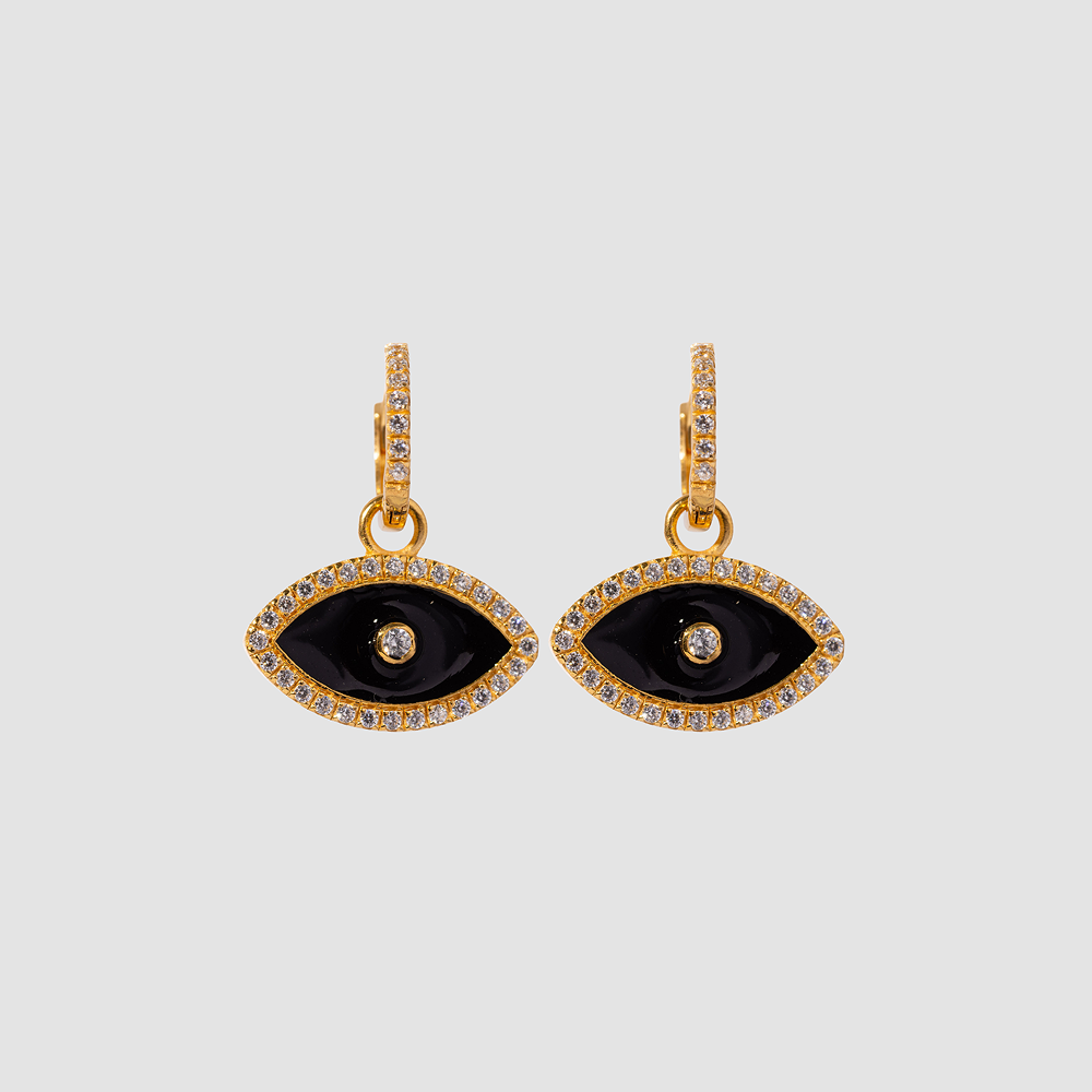 Pair of gold and black eye-shaped earrings on a light gray background