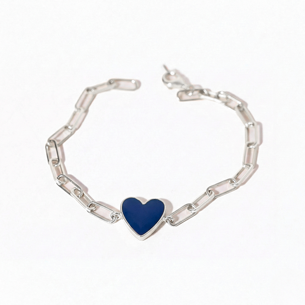 Silver bracelet with a blue heart charm on a white background