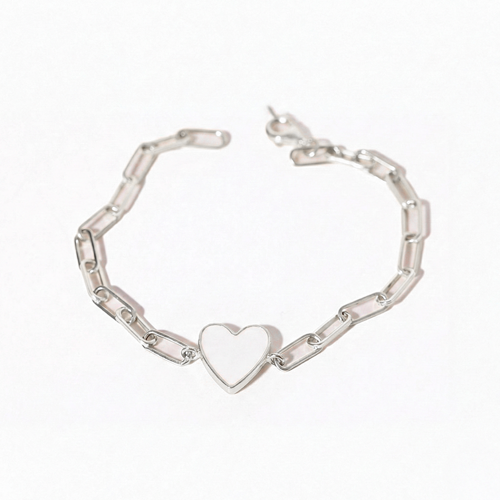Silver bracelet with a heart charm on a white background
