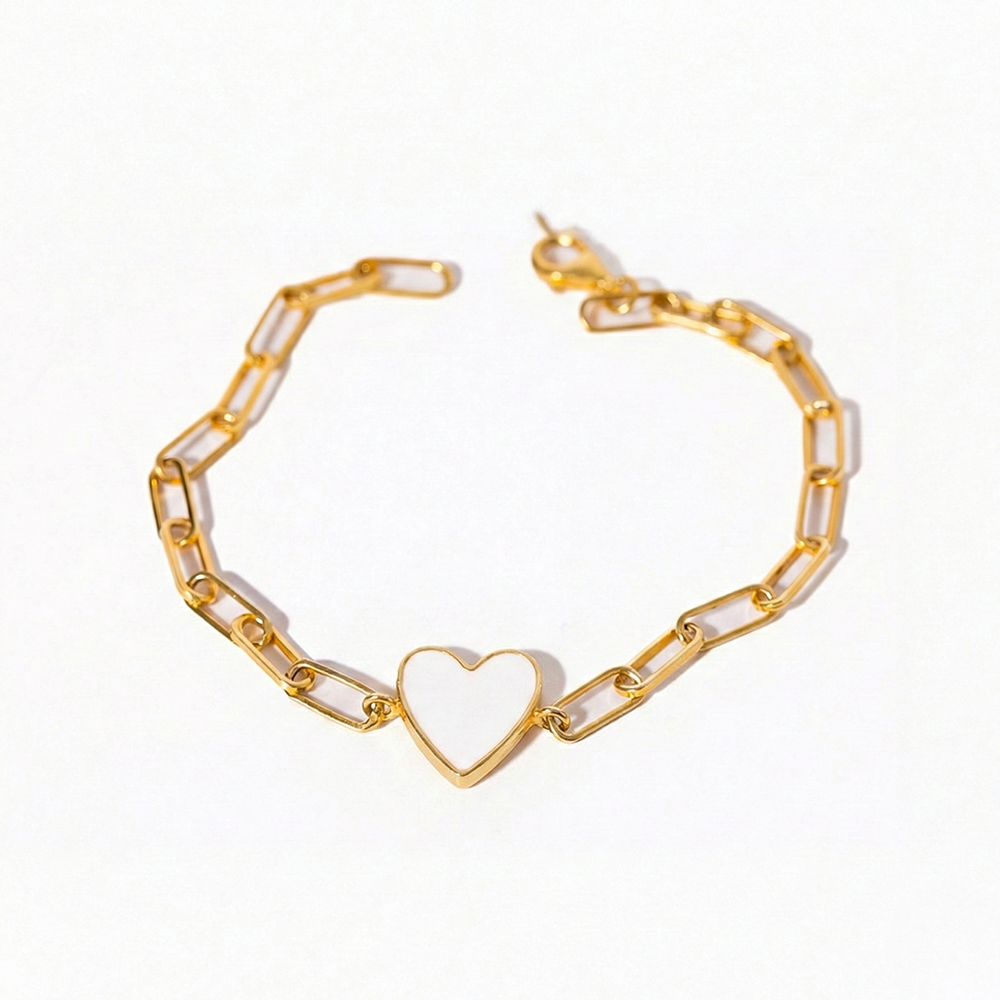 Gold bracelet with a heart-shaped charm on a white background